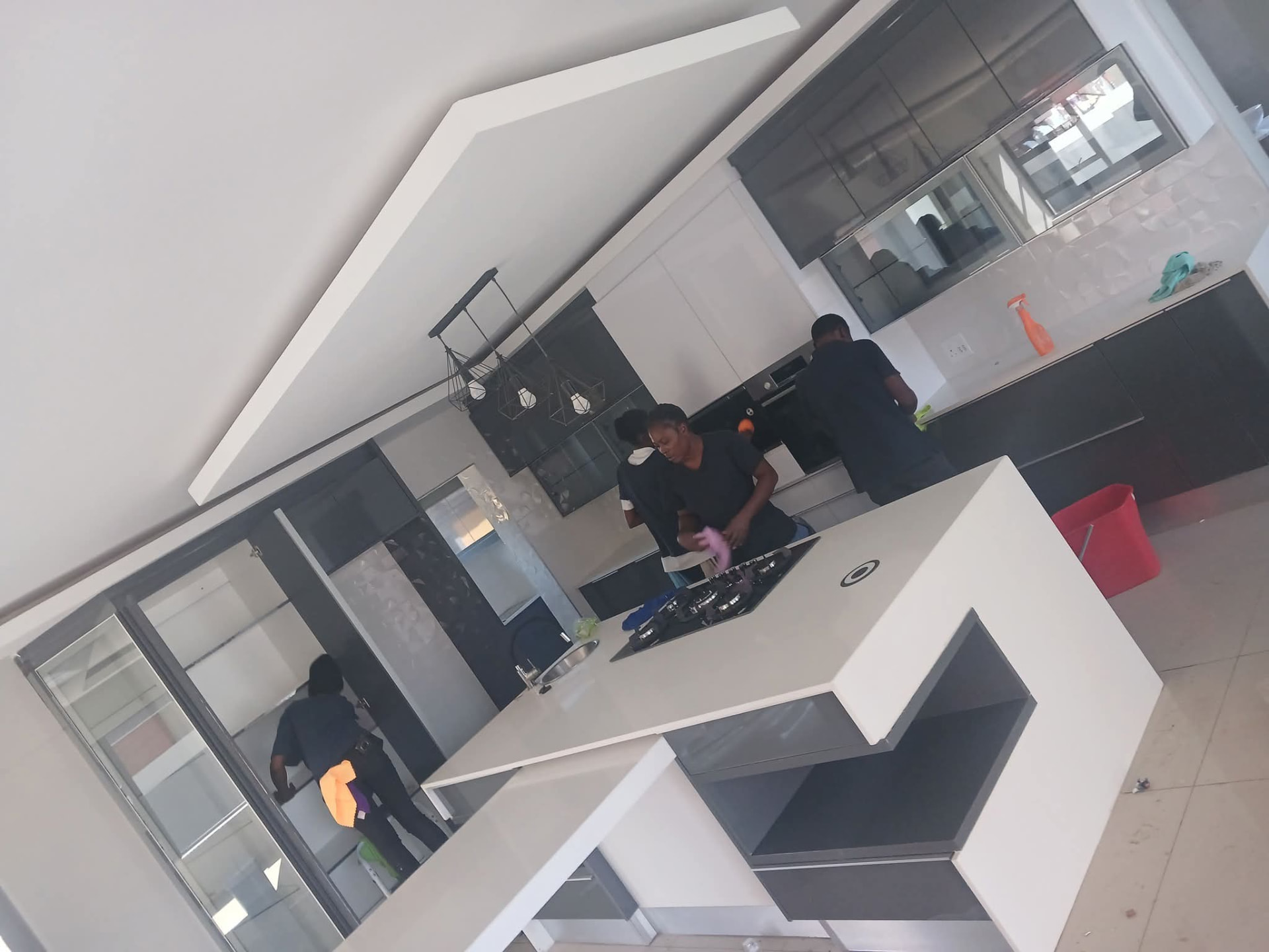 Estlas cleaners working in a modern kitchen